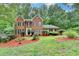 Traditional brick home with a lush lawn and mature trees in a peaceful setting at 2530 Ashbourne Dr, Lawrenceville, GA 30043