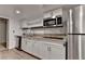 Kitchen featuring granite countertops, stainless steel microwave, and a stainless steel refrigerator at 2530 Ashbourne Dr, Lawrenceville, GA 30043