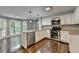 Well-lit kitchen with granite countertops, stainless steel appliances, and view to the yard at 2530 Ashbourne Dr, Lawrenceville, GA 30043