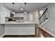 Kitchen with granite countertops, breakfast bar, stainless steel appliances and hardwood flooring at 2530 Ashbourne Dr, Lawrenceville, GA 30043