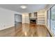 Inviting living room with a stone fireplace, hardwood floors, and built-in shelving at 2530 Ashbourne Dr, Lawrenceville, GA 30043