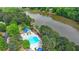 Beautiful aerial view of the large neighborhood pool, lake, and surrounding lush greenery at 2530 Ashbourne Dr, Lawrenceville, GA 30043