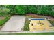 An aerial view of community recreational activities including volleyball, shuffleboard and cornhole at 2530 Ashbourne Dr, Lawrenceville, GA 30043