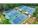A view of neighborhood tennis courts surrounded by lush trees and landscaping at 2530 Ashbourne Dr, Lawrenceville, GA 30043