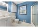 Light blue bathroom featuring a toilet, sink, vanity, and shower-tub combination at 3664 Pin Oak Cir, Atlanta, GA 30340
