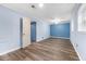 Bright blue bedroom with two windows, ceiling fan, and wood-look flooring at 3664 Pin Oak Cir, Atlanta, GA 30340