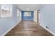 Spacious room with plank floors, and two windows providing natural light to the room at 3664 Pin Oak Cir, Atlanta, GA 30340