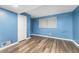 Bedroom featuring vinyl plank flooring, light blue walls, closet, window, and air vent at 3664 Pin Oak Cir, Atlanta, GA 30340