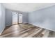 Bedroom with light blue walls, plank flooring, sliding glass door, and access to another room at 3664 Pin Oak Cir, Atlanta, GA 30340