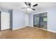 The bedroom features a ceiling fan, light blue walls, hardwood floors, a closet door, and a sliding glass door at 3664 Pin Oak Cir, Atlanta, GA 30340