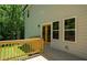 Wooden back deck with railings, and double glass doors that lead into a wooded area at 4366 Bradley Sw Dr, Snellville, GA 30039