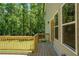 Exterior view of a wooden back deck with railings, and double glass doors, overlooking a wooded area at 4366 Bradley Sw Dr, Snellville, GA 30039