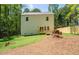 Backyard view of the home showing a patio, grass, the back of the house, and privacy fencing at 4366 Bradley Sw Dr, Snellville, GA 30039