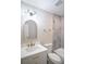 Bright bathroom with updated vanity and fixtures, stylish mirror, toilet, and tiled shower at 4366 Bradley Sw Dr, Snellville, GA 30039