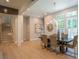 Elegant dining area with large windows, stylish chandelier, and staircase at 4366 Bradley Sw Dr, Snellville, GA 30039