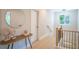 Upstairs hallway with wood floors, black railings and a decorative mirror at 4366 Bradley Sw Dr, Snellville, GA 30039
