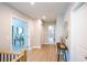 Second floor hallway featuring wood floors and an entrance to a full bathroom at 4366 Bradley Sw Dr, Snellville, GA 30039