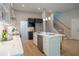 Modern kitchen features an island, stainless steel appliances, and white countertops at 4366 Bradley Sw Dr, Snellville, GA 30039