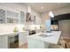 Stylish kitchen with marble countertops, a wine fridge, and contemporary lighting at 4366 Bradley Sw Dr, Snellville, GA 30039