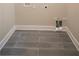 Neutral toned laundry room featuring wood-look tile floors and white trim at 4366 Bradley Sw Dr, Snellville, GA 30039