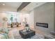 Inviting living room featuring a fireplace, modern decor, and seamless flow to the dining area at 4366 Bradley Sw Dr, Snellville, GA 30039