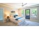 Well lit main bedroom with large windows, plush carpet, and a ceiling fan at 4366 Bradley Sw Dr, Snellville, GA 30039