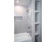 Bathroom shower with built-in shelves and a white tiled surround at 4366 Bradley Sw Dr, Snellville, GA 30039
