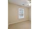 Bedroom with neutral colored walls, carpet, and a large window to let in light at 184 Darbys Crossing Ct, Hiram, GA 30141