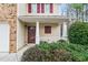 Inviting front porch with white columns and manicured bushes framing the entrance at 184 Darbys Crossing Ct, Hiram, GA 30141