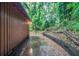 Narrow concrete patio with wood paneled wall next to natural lush overgrowth at 2046 Rector Sw Dr, Atlanta, GA 30311