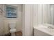 Modest bathroom featuring a toilet, sink, and a window offering natural light at 2046 Rector Sw Dr, Atlanta, GA 30311