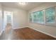 Bright bedroom featuring hardwood floors, and natural light from multiple windows at 2046 Rector Sw Dr, Atlanta, GA 30311