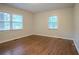 Sunlit bedroom with hardwood flooring and serene views from large windows at 2046 Rector Sw Dr, Atlanta, GA 30311