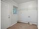 Functional laundry room with tiled floors, a window, and a door to the exterior at 2046 Rector Sw Dr, Atlanta, GA 30311