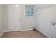 Functional laundry room with tiled floors, a window, and a door to the exterior at 2046 Rector Sw Dr, Atlanta, GA 30311