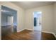 Spacious living room with hardwood floors and an open layout to the kitchen and entryway at 2046 Rector Sw Dr, Atlanta, GA 30311