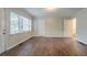 Spacious living room with hardwood floors, large window, and freshly painted walls at 2046 Rector Sw Dr, Atlanta, GA 30311