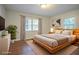 Staged primary bedroom with ample natural light, a decorative rug, and a comfortable bed at 2046 Rector Sw Dr, Atlanta, GA 30311