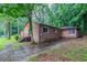 Side exterior view of a brick home with a paved driveway and green landscape at 2046 Rector Sw Dr, Atlanta, GA 30311