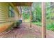 Backyard with wooden supports along side of the house with greenery around at 2218 Lowtrail Ct, Lithonia, GA 30058