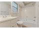 This well-lit bathroom has a shower and tub combination and a vanity with sink and faucet at 2218 Lowtrail Ct, Lithonia, GA 30058