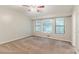 This is a bright bedroom with neutral colors, a ceiling fan and an abundance of light from multiple windows at 2218 Lowtrail Ct, Lithonia, GA 30058