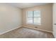 This bedroom features neutral colors, a window with blinds and carpeted floors at 2218 Lowtrail Ct, Lithonia, GA 30058