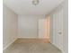 This bedroom has neutral colors and two doors, one leading to a closet or hall, and carpeted floors at 2218 Lowtrail Ct, Lithonia, GA 30058
