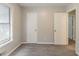 A bright bedroom offers neutral paint, carpet, and a window with blinds at 2218 Lowtrail Ct, Lithonia, GA 30058