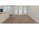 This inviting living room features neutral carpet and doors that open to an outdoor balcony and deck at 2218 Lowtrail Ct, Lithonia, GA 30058