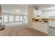 Inviting living area with large windows, neutral walls, and a smooth transition to the kitchen area at 2218 Lowtrail Ct, Lithonia, GA 30058