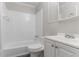 Clean white tiled bathroom featuring a bathtub and a vanity with sink at 2239 Carey Se Dr, Atlanta, GA 30315