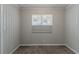Small bedroom with vertical paneling walls, neutral carpet, and a bright window at 2239 Carey Se Dr, Atlanta, GA 30315