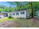 A quaint home showcasing a side view with lush greenery and a fenced yard at 2239 Carey Se Dr, Atlanta, GA 30315